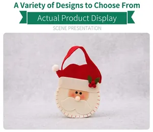 Detail of Santa Claus non-woven gift bag with handle against festive Christmas backdrop