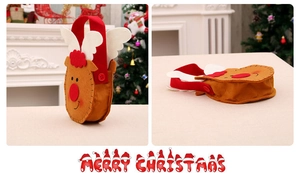 Detail of reindeer felt Christmas gift bag with red button handles on festive background