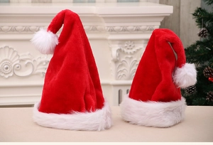 Detail of plush Christmas hats for adults and kids against a festive fireplace background