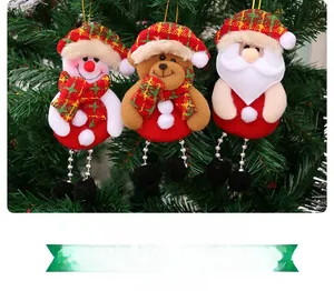 Detail of Christmas tree ornaments featuring plush Santa, snowman, and bear with bead chains