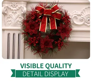 Close-up of Christmas wreath with red glitter bows and berries on a white fireplace
