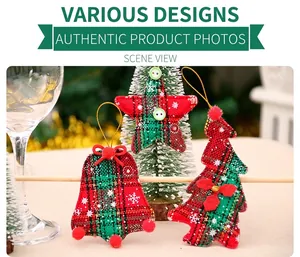 Detail of fabric Christmas ornaments with red and green plaid patterns and white snowflake print