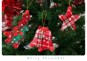 Detail of fabric Christmas ornaments with red and green plaid patterns on a tree