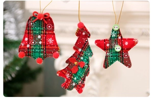 Detailed view of plaid Christmas ornaments with bells, stars, and festive bows
