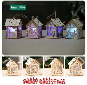 Close-up of small glowing wooden Christmas houses with LED light and twine hangers