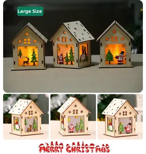 Close-up of glowing wooden Christmas cabin with Santa, elk and snowman cutouts