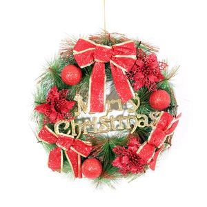 Artificial Christmas wreath with red bows, glitter poinsettia and Merry Christmas sign