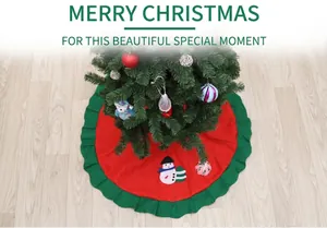 Detail of red Christmas tree skirt featuring snowman embroidery and green pleated edge