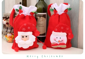 Close-up of Santa and Snowman felt gift bags with white faux fur trim and drawstrings
