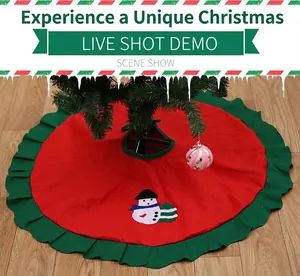 Detail of red Christmas tree skirt with green ruffled edges and snowman applique design