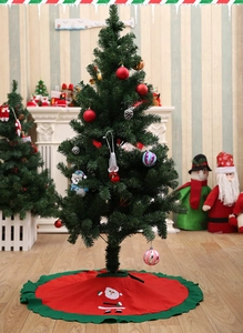 Close-up of a 90cm red Christmas tree skirt with Santa Claus and green ruffled edges