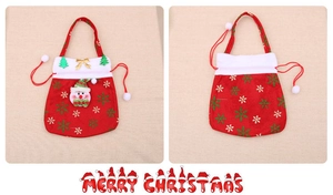Detail view of a red velvet Christmas gift bag with a 3D snowman and snowflake pattern