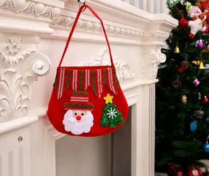 Detail of red felt Christmas gift bag featuring Santa Claus and a snowy tree decor