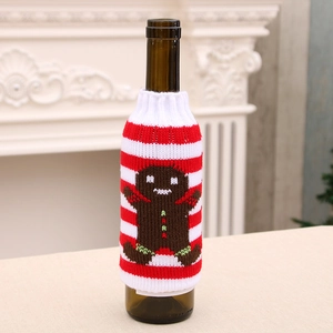 Knitted red and white striped Christmas beer bottle cover with gingerbread man design