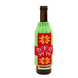 Knitted Christmas beer bottle sleeve with festive green knit and snowflake patterns