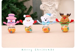 Detail of mini Christmas candy jars featuring snowman, santa, bear and reindeer plush tops