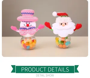 Close-up of Christmas candy jars featuring knitted Santa and snowman character lids