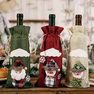 Detailed view of rustic burlap Christmas wine bottle covers with embroidery and wood buttons