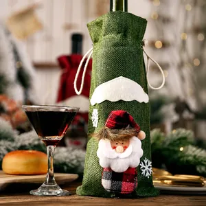 Close-up of green burlap Christmas wine bottle cover with 3D Santa and snowflake decor