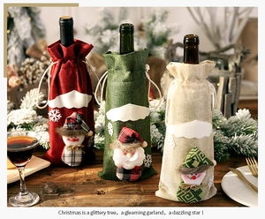 Detailed view of burlap Christmas wine bottle bags with plush snowman and Santa decor