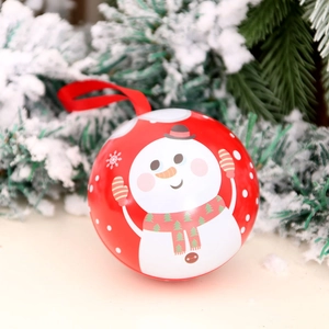 Red Christmas ornament ball with snowman illustration on snowy pine tree branch
