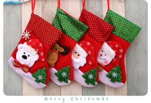 Detail view of 3D Santa and reindeer Christmas stockings on rustic wood background