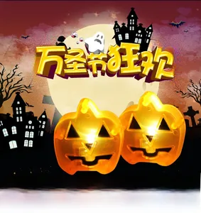 Detail showing two orange glowing LED pumpkin lanterns with festive Halloween graphics