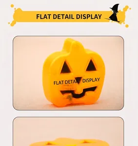 Macro detail of a flat orange pumpkin LED light with a carved face for Halloween decor