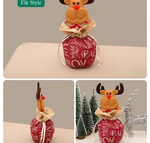 Detail of red linen Christmas gift bag with 3D plush reindeer and festive JOY print