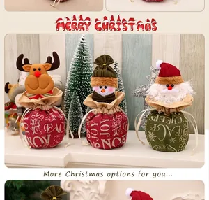 Detail of Christmas burlap drawstring gift bags with Santa and reindeer plush figures