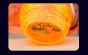 Detail view of translucent orange plastic cup bottom with textured non-slip surface