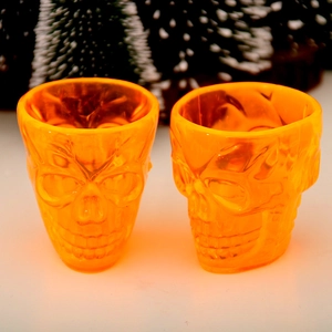 Halloween orange skull shaped glass cups with embossed detail for party decoration