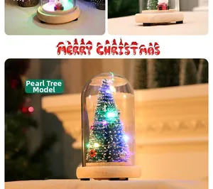 Detail of a Christmas glass dome pearl tree with colorful LED lights on wood base