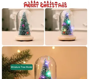 Detail of lit Christmas tree in glass dome with wood base and colorful LED lights