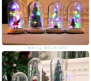 Close-up of LED mini Christmas tree in glass dome with wood base and Santa Claus
