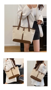 Detail of canvas tote bag showing brown leather trim and golden metal lock closure