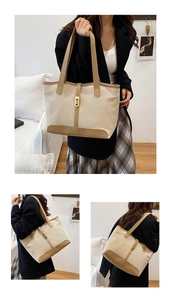 Detail of canvas tote bag with contrast leather trim and golden square buckle closure