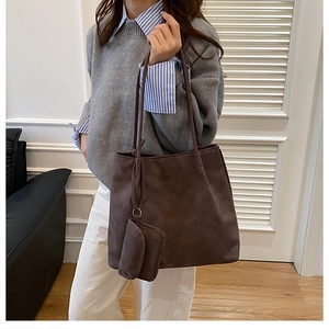 Detail of coffee brown suede tote bag featuring a matching small coin purse attachment