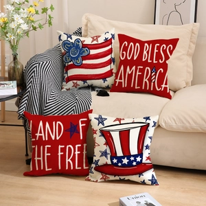 Set of 4 American Independence Day pillow covers with patriotic prints on a beige sofa