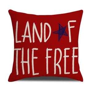 Detail of red pillow cover with Land of the Free text and blue star for July 4th decor