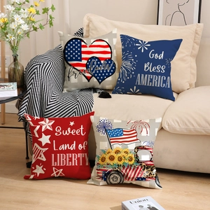 Detail of four USA Independence Day pillow covers with patriotic prints on a white sofa