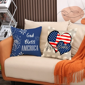 Detail of God Bless America and Freedom heart throw pillow covers on a sofa
