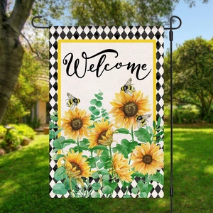 Garden flag detail showing a welcome message with sunflower and bee on a burlap texture