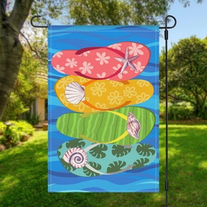 Close-up of summer beach garden flag with colorful flip-flops on a black metal stand