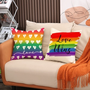 Linen Pride pillow covers with rainbow Love Wins design on a modern beige sofa