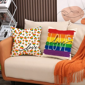 Set of 2 rainbow heart and stripe linen throw pillow covers on a cozy sofa
