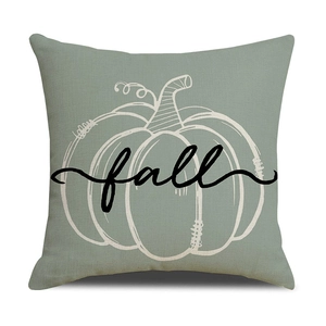 Detail of sage green linen pillow cover featuring white pumpkin outline and fall script