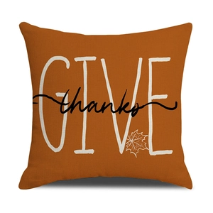 Detail of burnt orange Thanksgiving pillow cover with Give Thanks typography and maple leaf