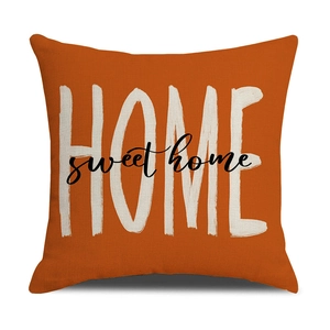 Close-up of linen pillow cover with Home Sweet Home text and rustic fabric texture