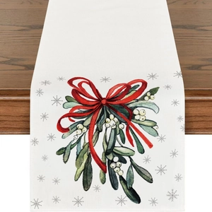 Linen Christmas table runner featuring watercolor holly leaves and red ribbon bow patterns